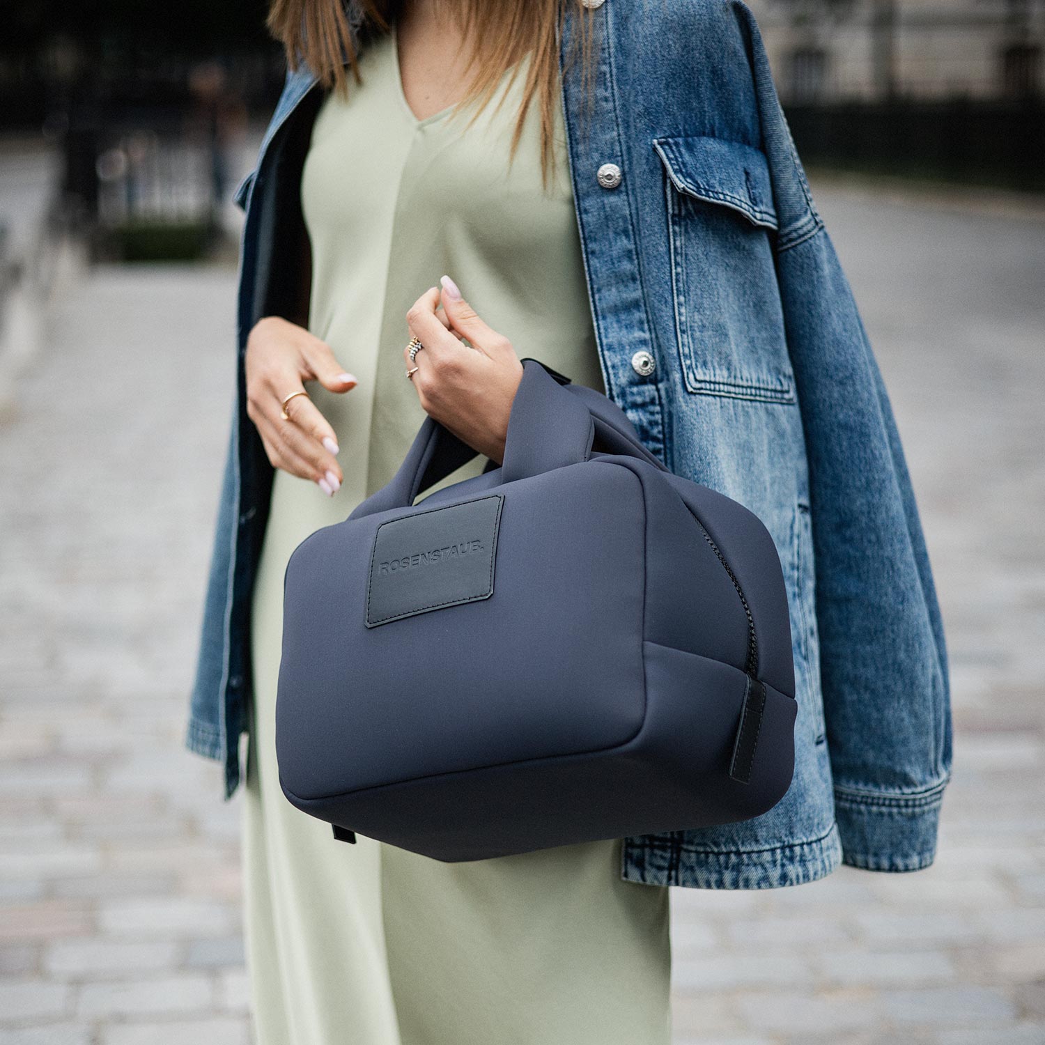 Close-up of a woman wearing a Rosenstaub Bauletto bag in Jardin du Luxembourg, Paris